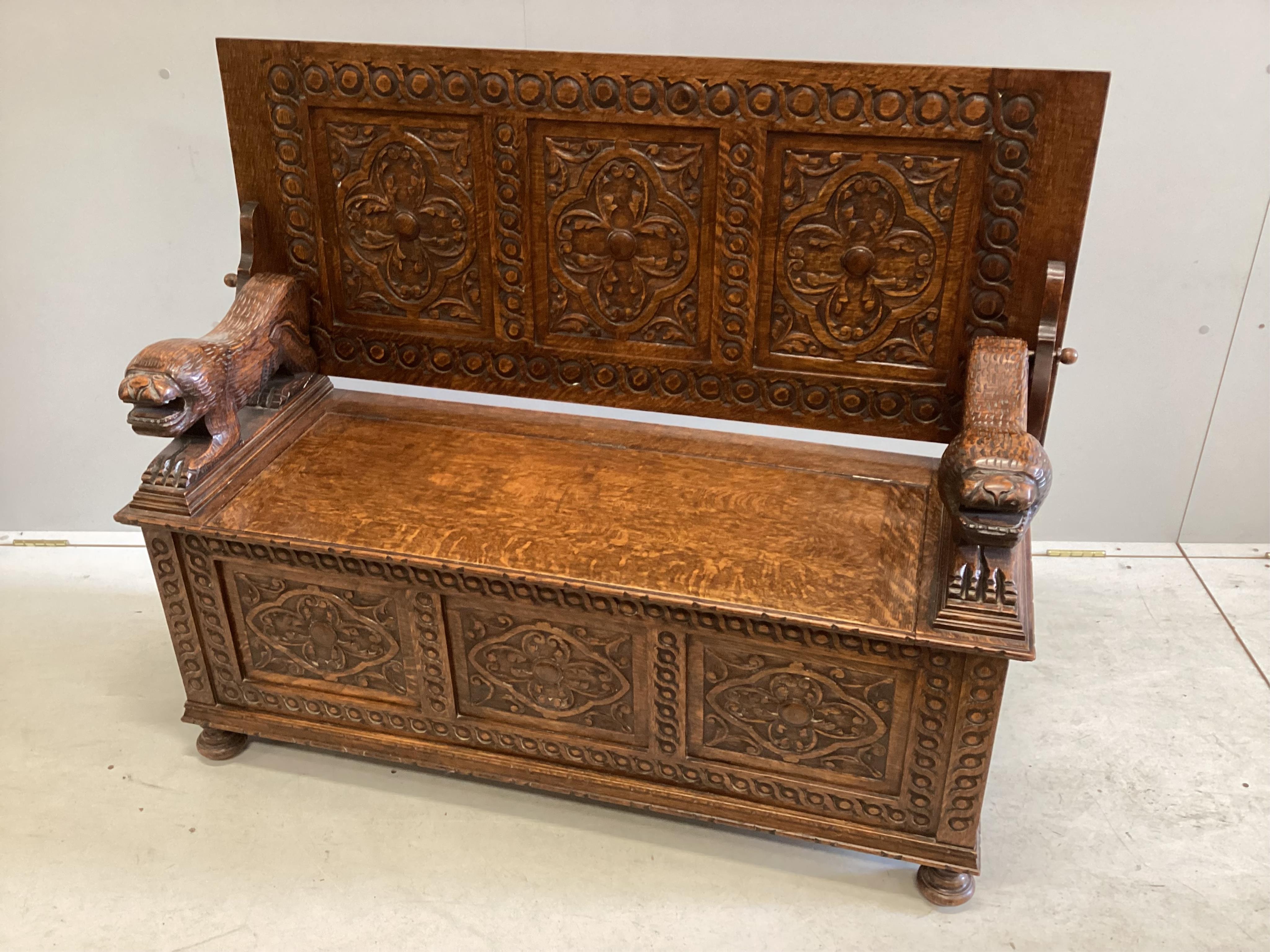 An early 20th century carved oak monk's bench, width 125cm, depth 49cm, height 98cm. Condition - good